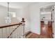 Upper hallway with wood floors and a chandelier, leading to bedroom with furnishings at 104 Beach St, Mount Pleasant, SC 29464