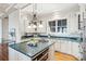 Gourmet kitchen with an island, stainless steel appliances, and custom cabinetry at 104 Beach St, Mount Pleasant, SC 29464