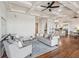 Open-concept living space with a coffered ceiling, hardwood floors, and seamless flow to the kitchen at 104 Beach St, Mount Pleasant, SC 29464