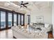 Cozy living room with hardwood floors, coffered ceilings, and large windows offering picturesque views at 104 Beach St, Mount Pleasant, SC 29464