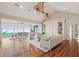 Spacious living room with wood floors, built-ins, and views of the pier and ocean at 104 Beach St, Mount Pleasant, SC 29464