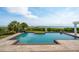 Stunning geometric pool with brick trim and views of the ocean and lush green surroundings at 104 Beach St, Mount Pleasant, SC 29464