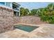 Charming, intimate plunge pool enclosed by brick walls and surrounded by a tile deck at 104 Beach St, Mount Pleasant, SC 29464