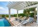 Relaxing poolside lounge area with stylish chaise lounges and a beautiful pergola at 104 Beach St, Mount Pleasant, SC 29464