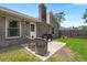 Brick home exterior with grill, patio furniture, and a well-maintained lawn at 106 Brown Ct, Summerville, SC 29486