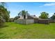 Wide shot of grassy backyard with brick home exterior and wooden privacy fence at 106 Brown Ct, Summerville, SC 29486