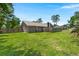 Large backyard view showing the brick home exterior with well-maintained green lawn at 106 Brown Ct, Summerville, SC 29486
