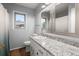Bathroom featuring a granite countertop, tile floors, and a framed mirror at 106 Brown Ct, Summerville, SC 29486