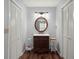 Charming bathroom with a vanity, a round mirror, and wood-look flooring at 106 Brown Ct, Summerville, SC 29486