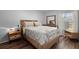 Bright bedroom with a wood-look bed frame, a window, and a dresser with mirror at 106 Brown Ct, Summerville, SC 29486