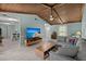 Comfortable living room with wooden ceilings, tile floors, grey sectional and natural light at 106 Brown Ct, Summerville, SC 29486