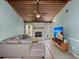 Living room with fireplace, light blue walls, exposed-beam ceiling, tv and tile floors at 106 Brown Ct, Summerville, SC 29486