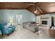 Cozy living room with exposed-beam ceiling, fireplace, tile floors, and comfortable seating at 106 Brown Ct, Summerville, SC 29486