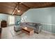 Comfortable living room with light blue walls, tile floors, grey sectional sofa and natural light at 106 Brown Ct, Summerville, SC 29486