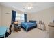 A spacious bedroom with a ceiling fan, rocking chair and blue and white color scheme at 1115 O T Wallace Blvd, Moncks Corner, SC 29461