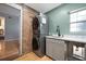 Laundry area showcases stacked washer and dryer, a convenient sink, and unique brick wall accent at 1115 O T Wallace Blvd, Moncks Corner, SC 29461