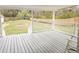 Covered back porch overlooking spacious backyard with wooden fence and mature trees at 132 Tranquil Ln, Ladson, SC 29456