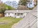 The backyard has a white exterior with a small covered porch and a spacious lawn at 132 Tranquil Ln, Ladson, SC 29456