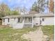 Exterior view of the back of the home, featuring a covered porch and white brick at 132 Tranquil Ln, Ladson, SC 29456