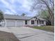 Charming single-story home with a two-car garage and a well-maintained front yard, showcasing curb appeal at 132 Tranquil Ln, Ladson, SC 29456