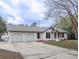 Charming white brick home with a two-car garage, driveway, and well-maintained yard at 132 Tranquil Ln, Ladson, SC 29456