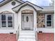 Inviting entryway with stone accents and a decorative glass door creating a warm welcome at 132 Tranquil Ln, Ladson, SC 29456
