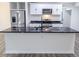 Modern kitchen featuring sleek black countertops, stainless steel appliances, and stylish white cabinetry at 132 Tranquil Ln, Ladson, SC 29456