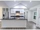Bright kitchen with an island, stainless steel appliances, modern white cabinets and granite counters at 132 Tranquil Ln, Ladson, SC 29456