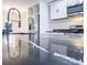 Stylish kitchen island with black countertops, modern sink and stainless-steel appliances at 132 Tranquil Ln, Ladson, SC 29456