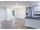 Open-concept kitchen and dining area with hardwood floors, stainless steel appliances and natural light at 132 Tranquil Ln, Ladson, SC 29456
