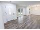 Bright living room featuring hardwood floors, white trim, and a decorative front door at 132 Tranquil Ln, Ladson, SC 29456