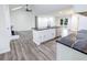 Open-concept living room and kitchen area featuring hardwood floors, modern decor, and vaulted ceilings at 132 Tranquil Ln, Ladson, SC 29456