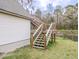Wooden staircase attached to the shed, leading to an upper level entrance at 132 Tranquil Ln, Ladson, SC 29456