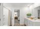 Bright bathroom with double vanity sinks, a large mirror, and access to a walk-in shower and bedroom at 133 Haventree Ct, Summerville, SC 29486
