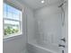 Bright bathroom featuring a shower-tub combination and a window with a view at 133 Headwater Dr, Summerville, SC 29486