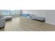 Bright bonus room with wood floors, built-in shelving, and gray upholstered bench seat for stylish storage solutions at 133 Headwater Dr, Summerville, SC 29486