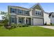 Two story home with gray siding, white trim and a large front yard at 133 Headwater Dr, Summerville, SC 29486