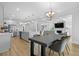 Open concept living space with modern kitchen, dining area, living room, fireplace and staircase at 133 Headwater Dr, Summerville, SC 29486