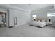 Spacious main bedroom featuring tray ceiling, plush carpet, and a large bed, perfect for relaxation at 133 Headwater Dr, Summerville, SC 29486