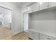 Hallway with built-in mudroom storage featuring cabinets, hooks, and a bench seat at 133 Headwater Dr, Summerville, SC 29486