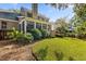 Green backyard featuring a well-manicured lawn, mature trees, and an inviting deck area at 1330 Somersby Ln, Mount Pleasant, SC 29466