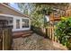 Landscaped backyard features stone pathway, fence, and stairs to the deck and a treehouse at 1330 Somersby Ln, Mount Pleasant, SC 29466