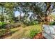Well-maintained backyard with lush grass, mature trees, and a charming wooden treehouse at 1330 Somersby Ln, Mount Pleasant, SC 29466