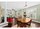 Charming dining area featuring hardwood floors, a bright window and access to the sun-lit living room and staircase at 1330 Somersby Ln, Mount Pleasant, SC 29466