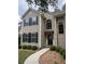 Two-story home with neutral siding, black shutters, manicured landscaping, and a concrete walkway to the front door at 1330 Somersby Ln, Mount Pleasant, SC 29466