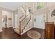 Spacious foyer with hardwood floors, staircase with carpet runner, and a clear view to a naturally lit hall and staircase at 1330 Somersby Ln, Mount Pleasant, SC 29466