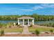 Scenic gazebo on a lush landscaped lot near a beautiful pond and green trees at 1330 Somersby Ln, Mount Pleasant, SC 29466