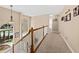 Light-filled hallway featuring wood railings and multiple framed pictures on the wall at 1330 Somersby Ln, Mount Pleasant, SC 29466