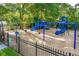 Community playground with swings, slides, and climbing structures surrounded by a black metal fence at 1330 Somersby Ln, Mount Pleasant, SC 29466