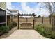 Relaxing backyard features a charming swing, a wooden fence, and lush landscaping at 136 Stagecoach Ln, Summerville, SC 29483